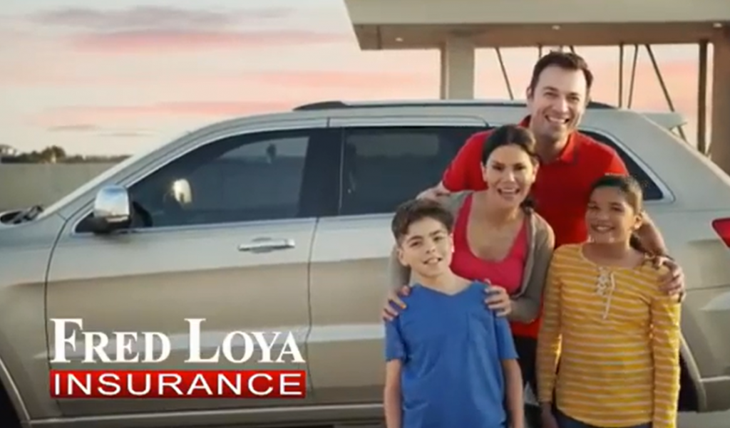 Smiling family of four standing in front of their SUV, promoting Fred Loya Insurance for affordable auto coverage.